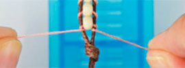 Beads being knotted to cord